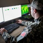 Military IT person in fatigues using a computer